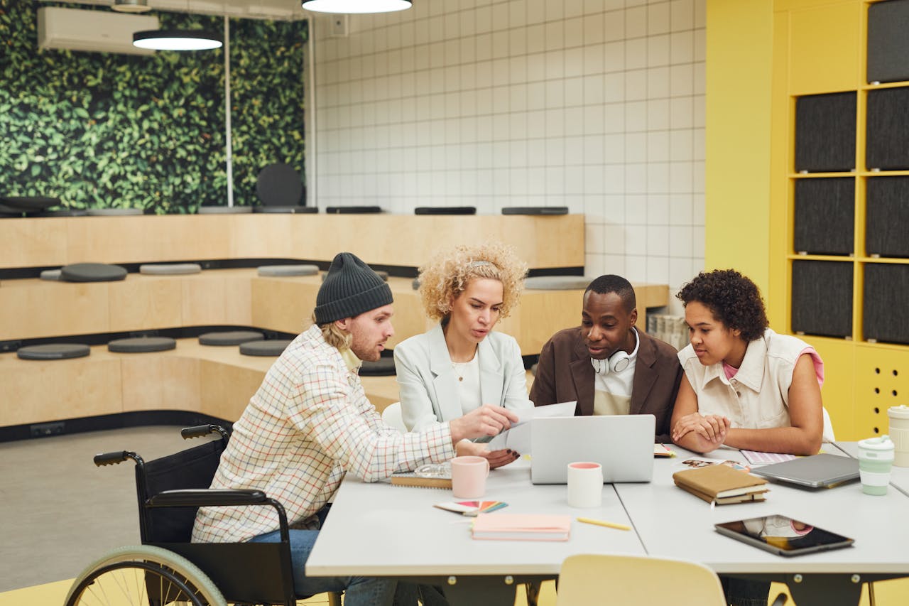 Diverse team collaborating in a modern office setting, fostering inclusive teamwork and discussion.